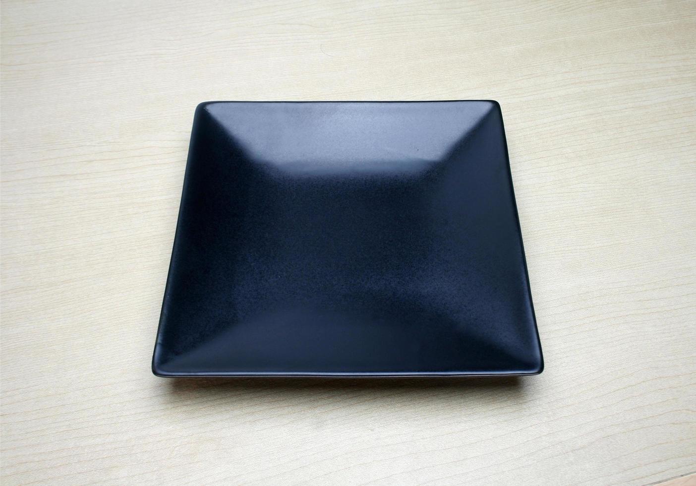 fyrkantig svart tallrik på bordet foto