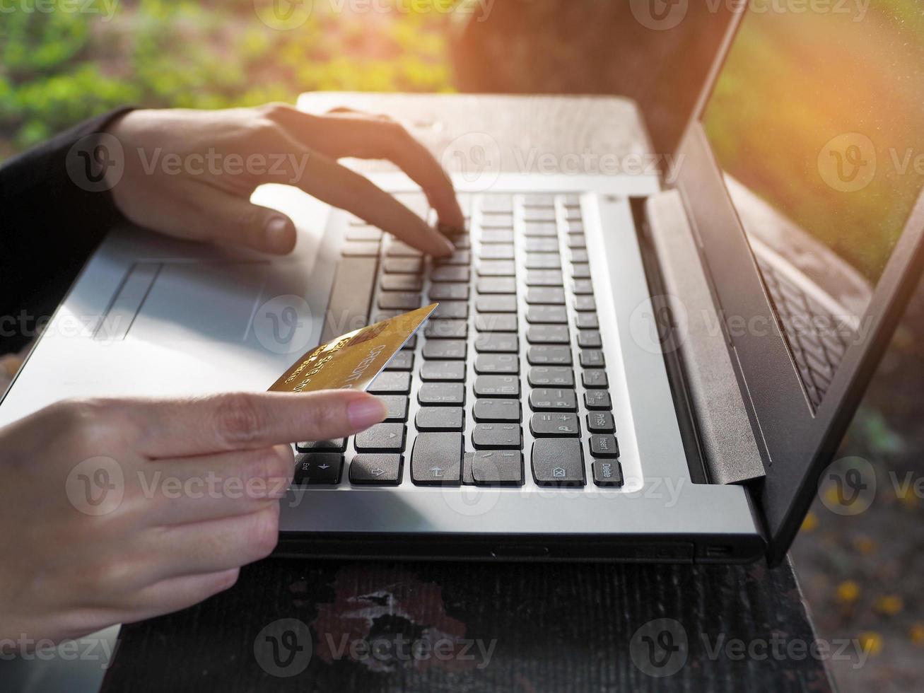 affärskvinna använder sig av kreditera kort betalande för Produkter via bärbar dator uppkopplad handla .bekvämlighet i utgifterna foto