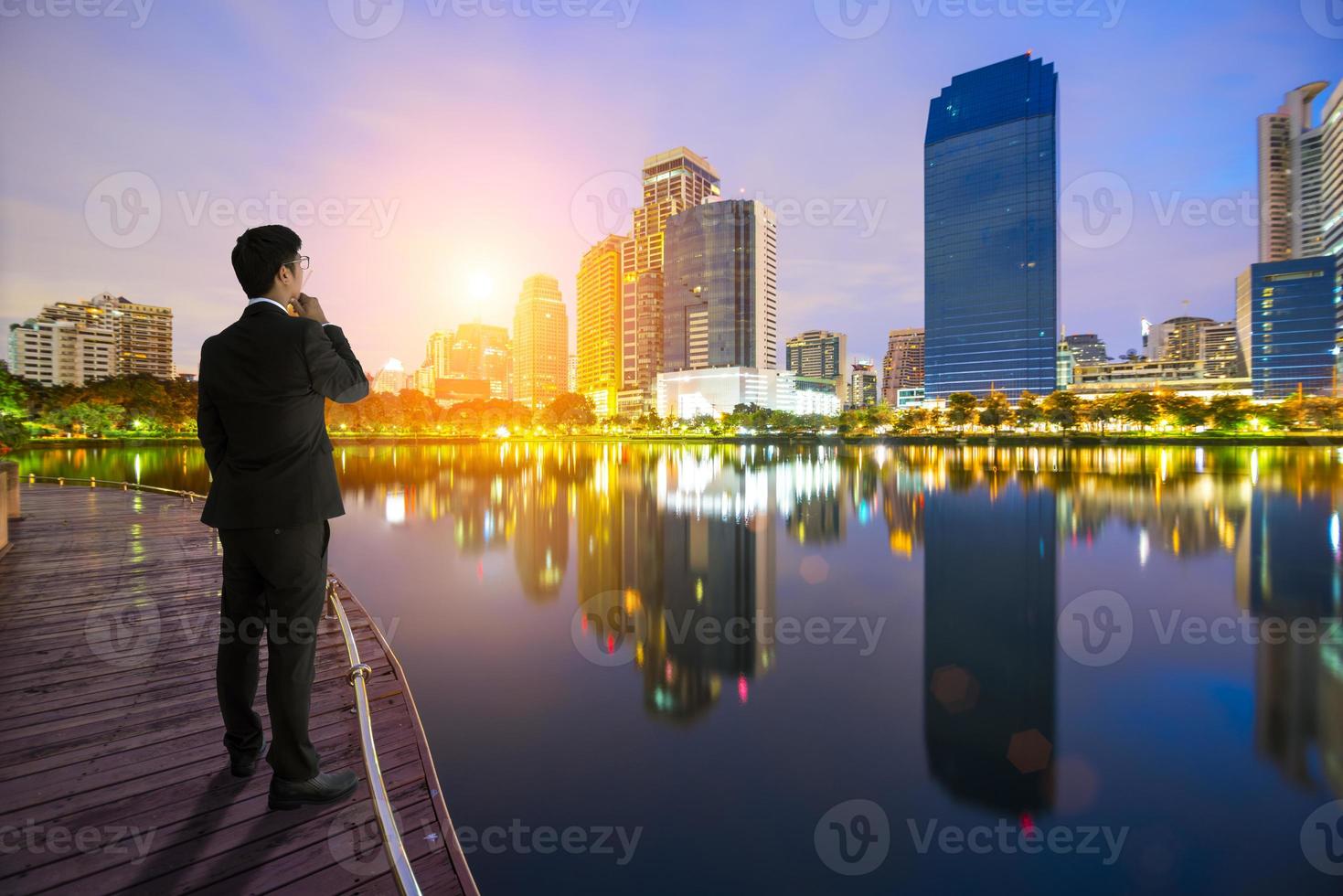 affärsman som tittar på staden vid soluppgång foto