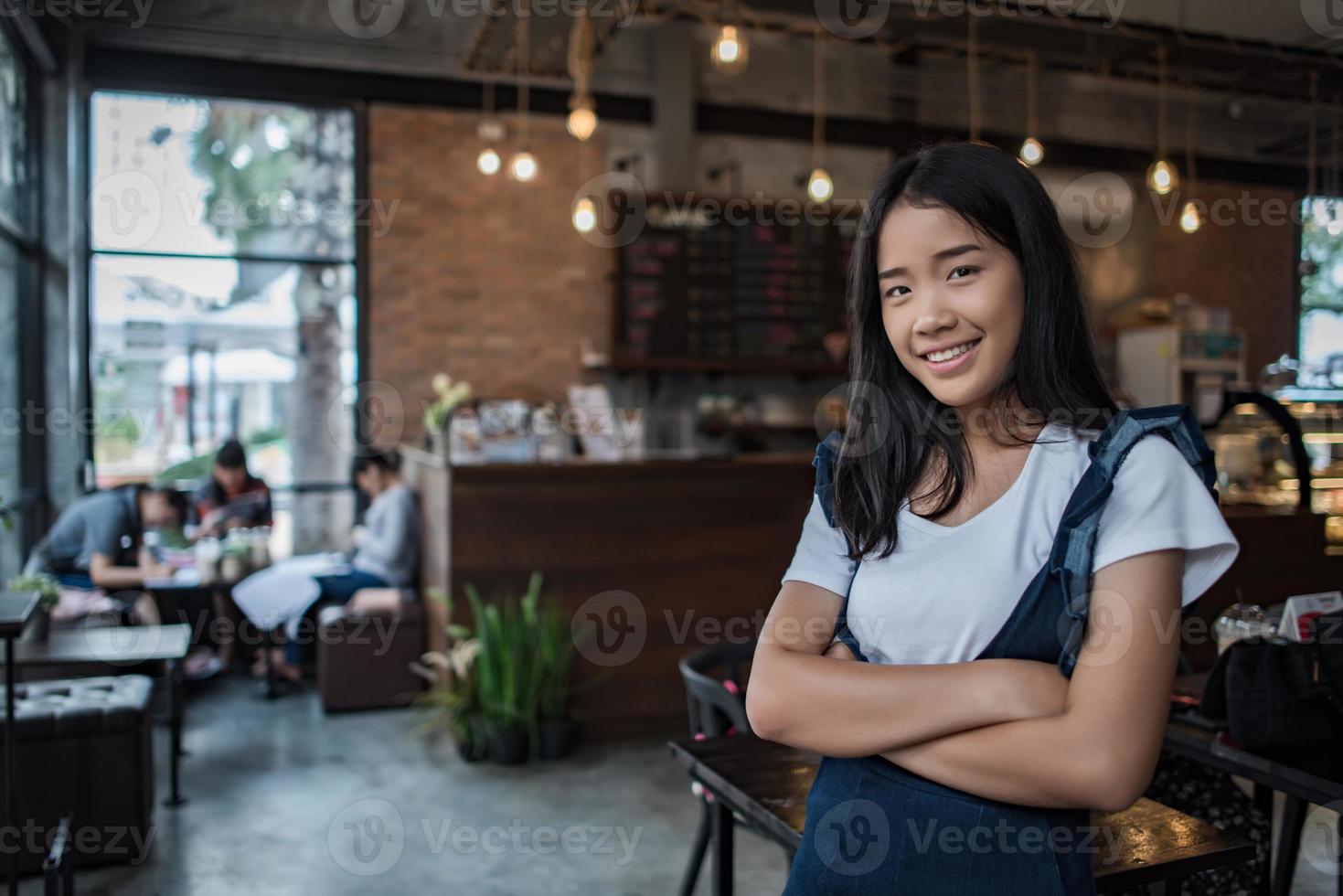 stående av en ung kvinna som ler i kafékafé foto