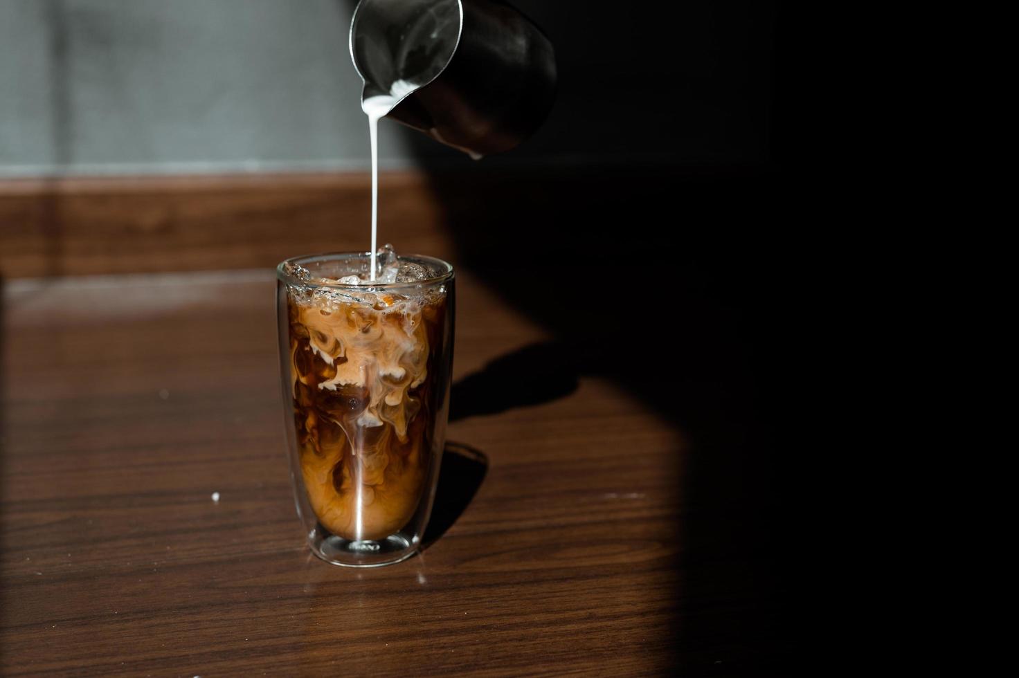 glas kaffe med mjölk på bordet foto