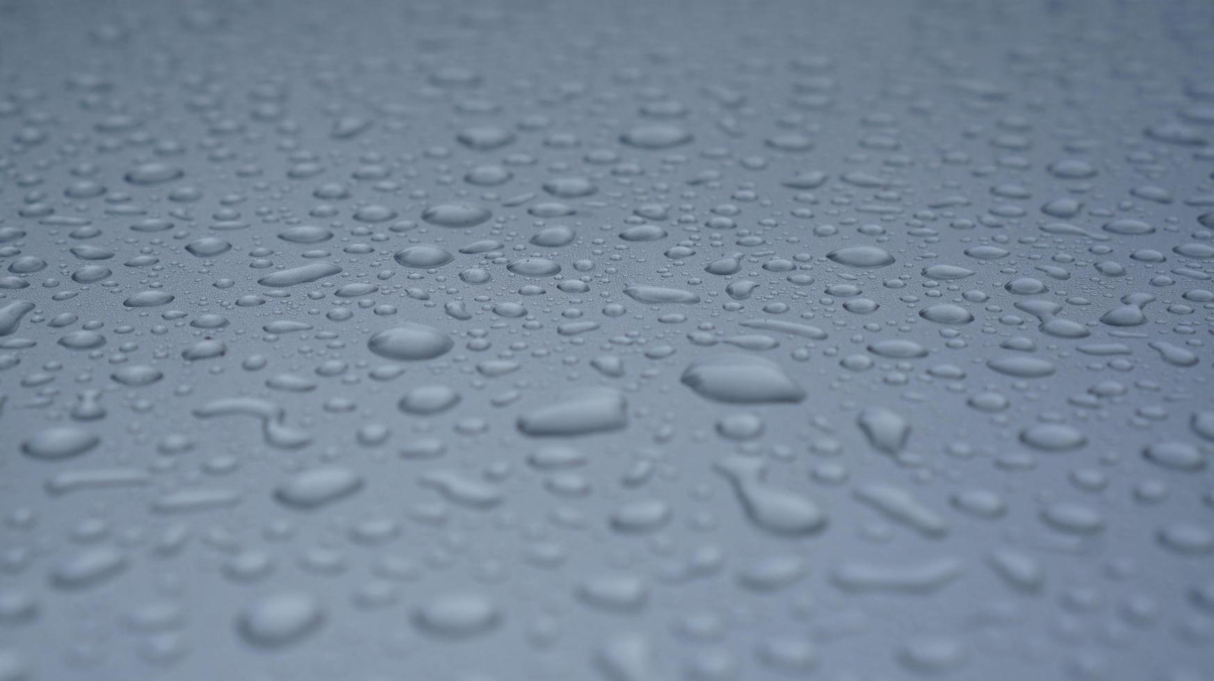 vattendroppe på en yta av ett grått isolerat fönster foto