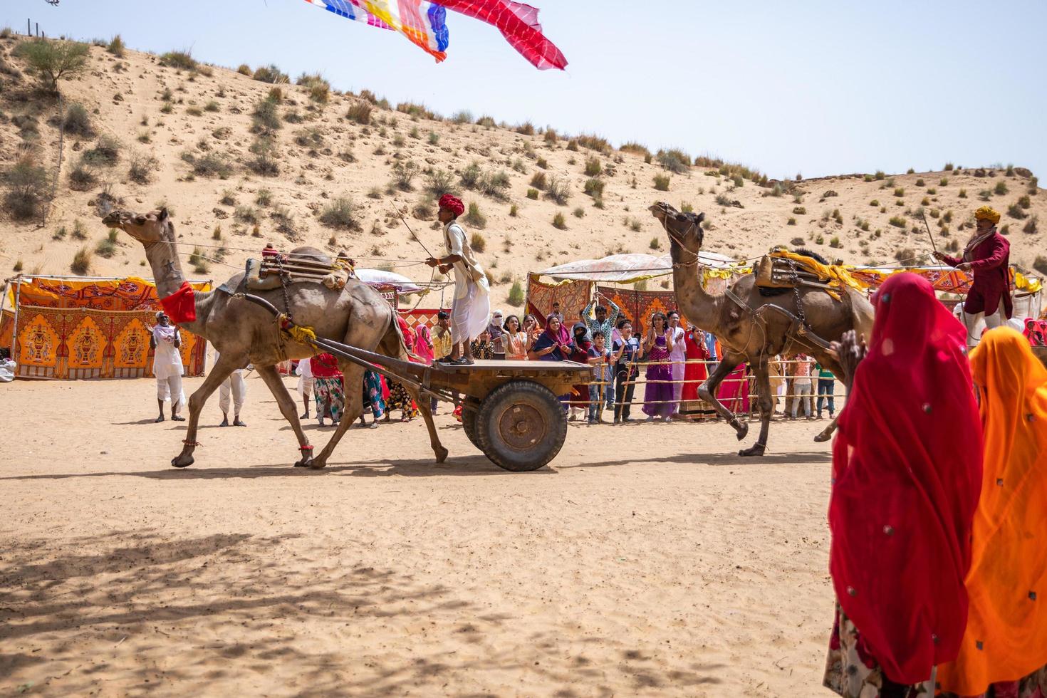 rajasthan, indien 2018 - människor som rider vagnar med kameler genom öknen foto