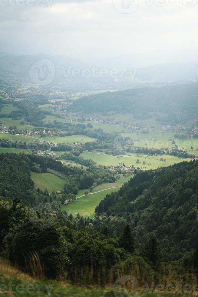 majestätisk bergen i de alps täckt med träd och moln foto