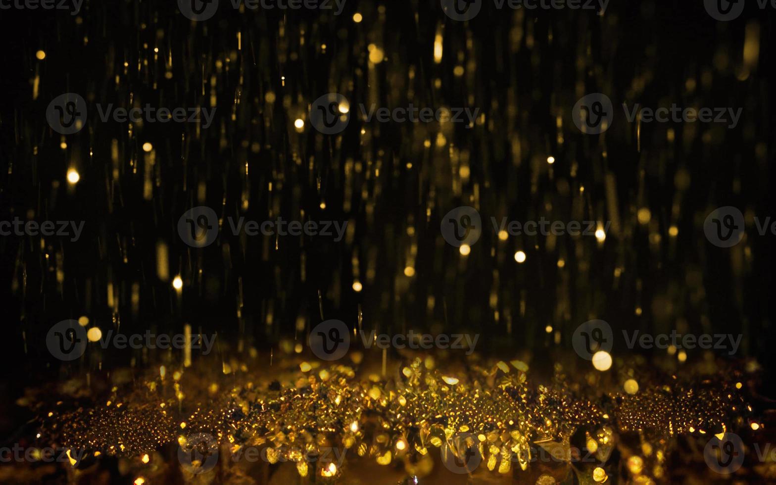 guld partikel bokeh på svart bakgrund foto