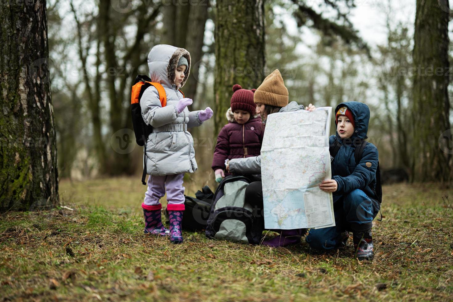 mor och barn med Karta i de skog. foto