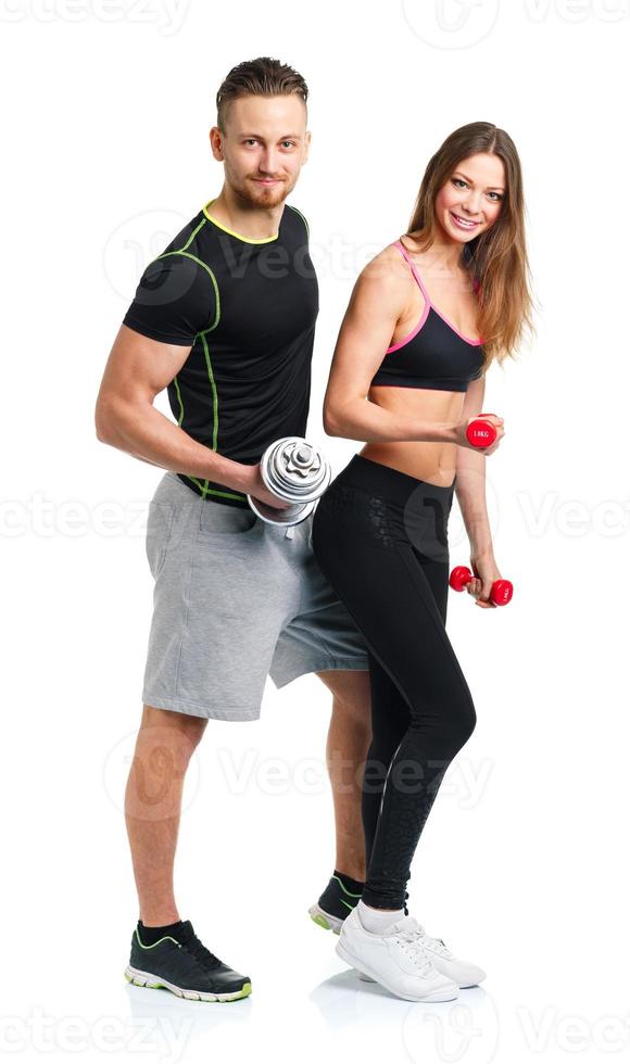atletisk man och kvinna med hantlar på de vit foto