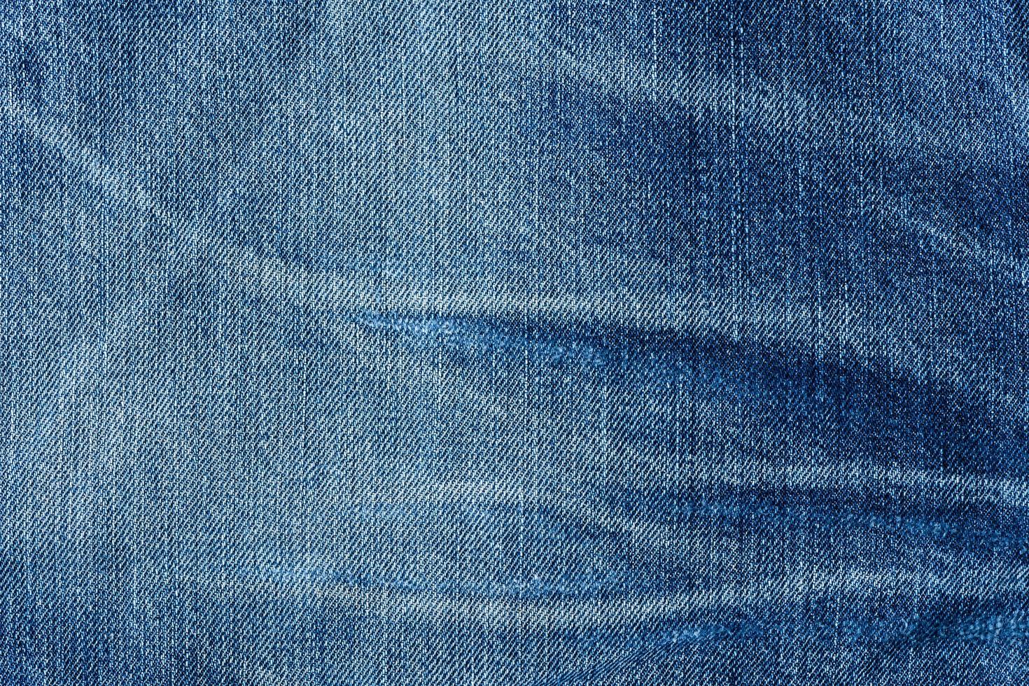 gammal blå jeans tyg bakgrund textur. stänga upp foto