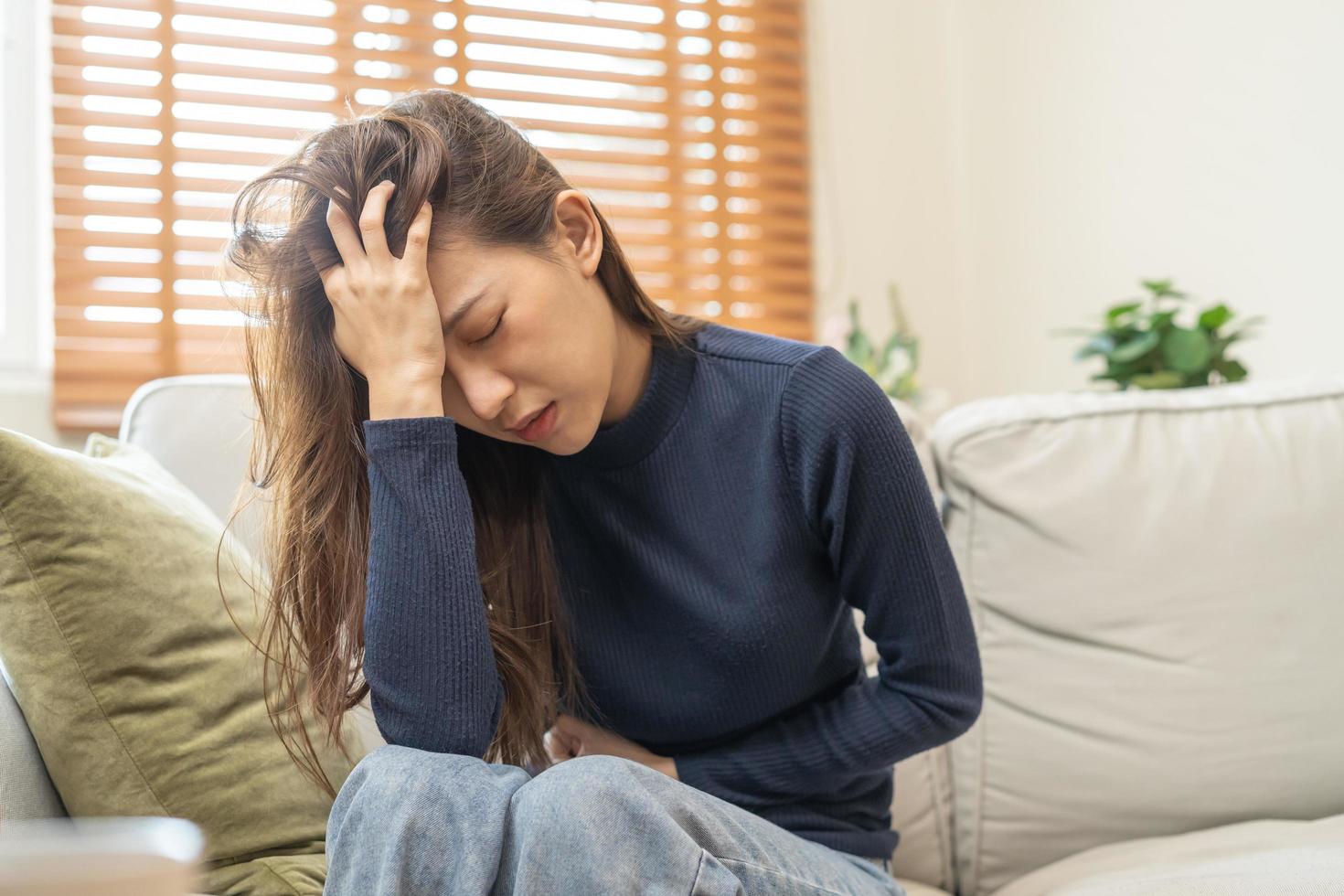 flatulens asiatisk ung kvinna, flicka hand i mage värk, lida från mat förgiftning, abdominal smärta och kolon problem, gastrit eller diarre. patient mage, buk eller inflammation, begrepp. foto