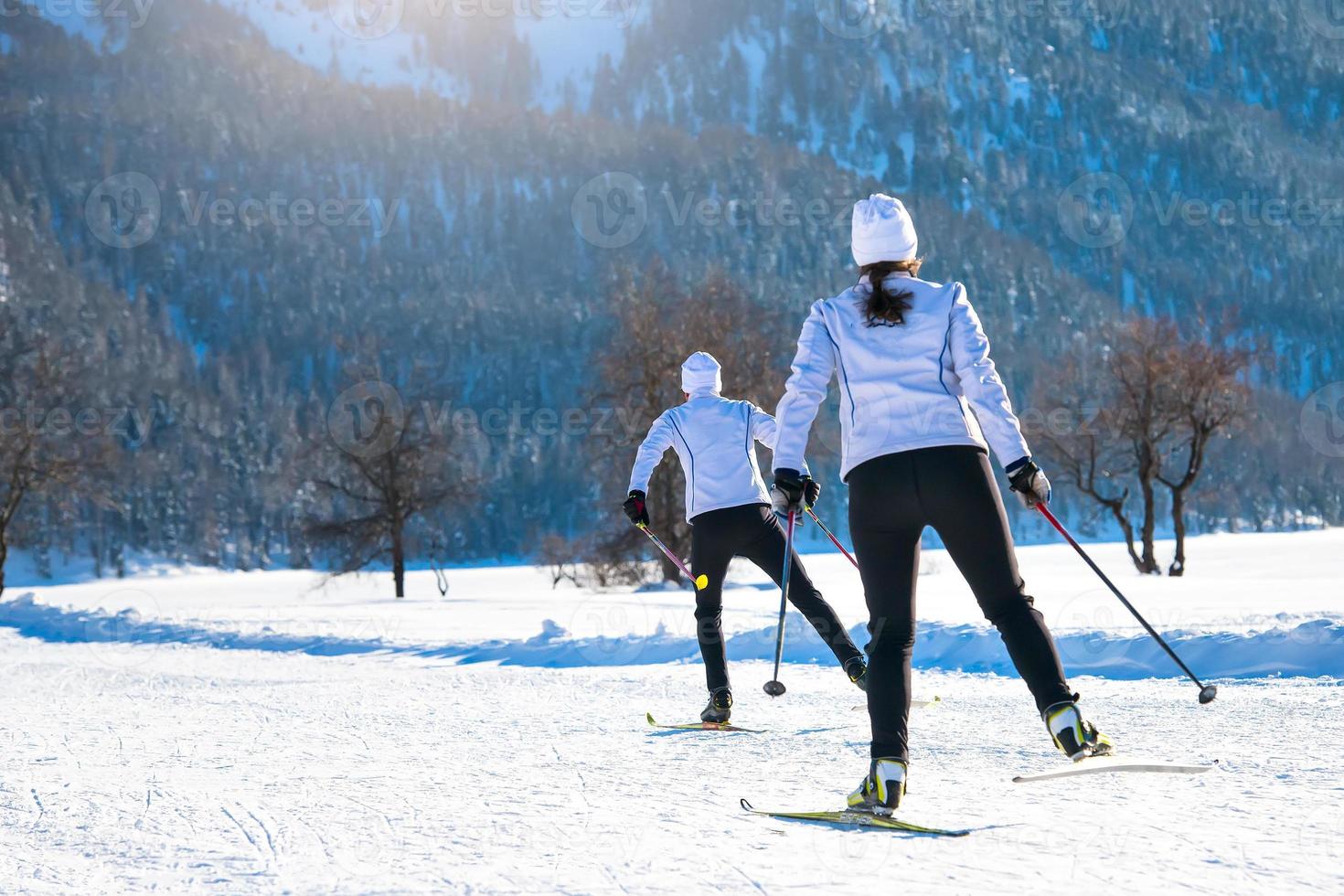 par man och kvinna längdskidåkare med skridskoåkningsteknik foto