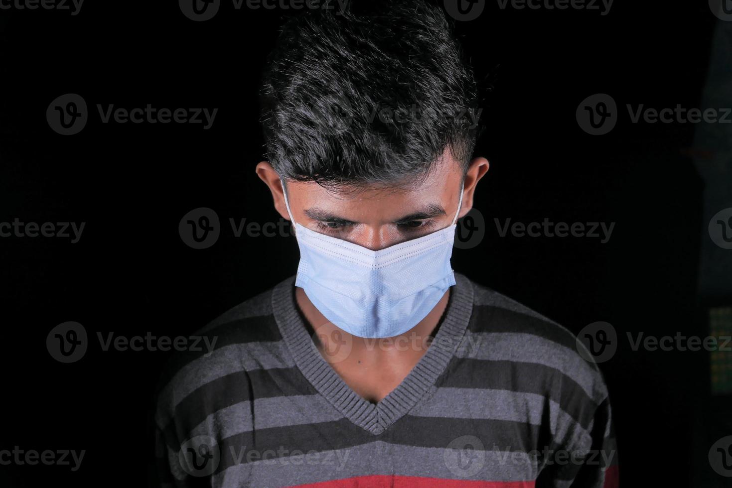en ung man med skyddande mask isolerad på svart foto