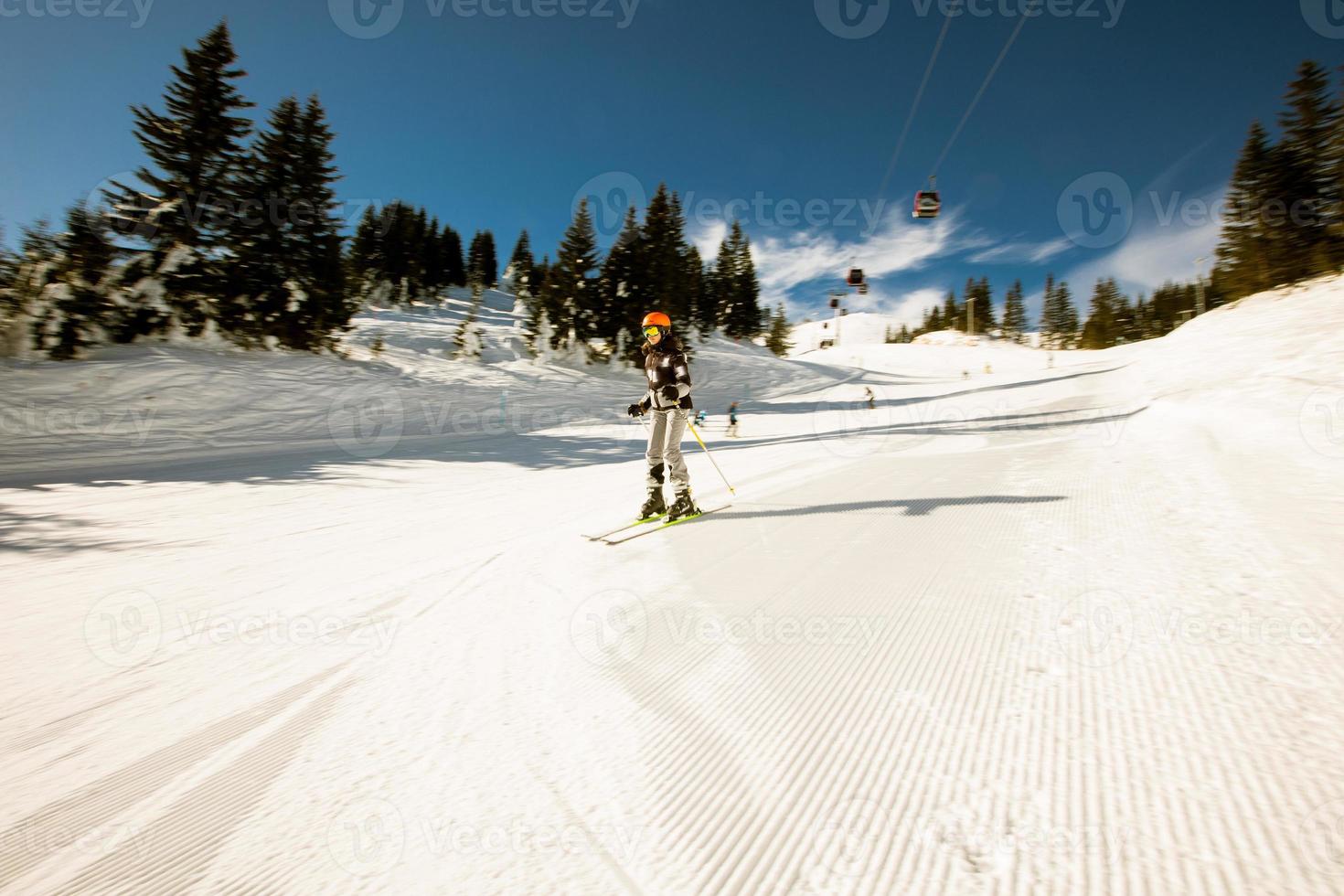 flicka på vinter- skidåkning salighet, en solig dag äventyr foto