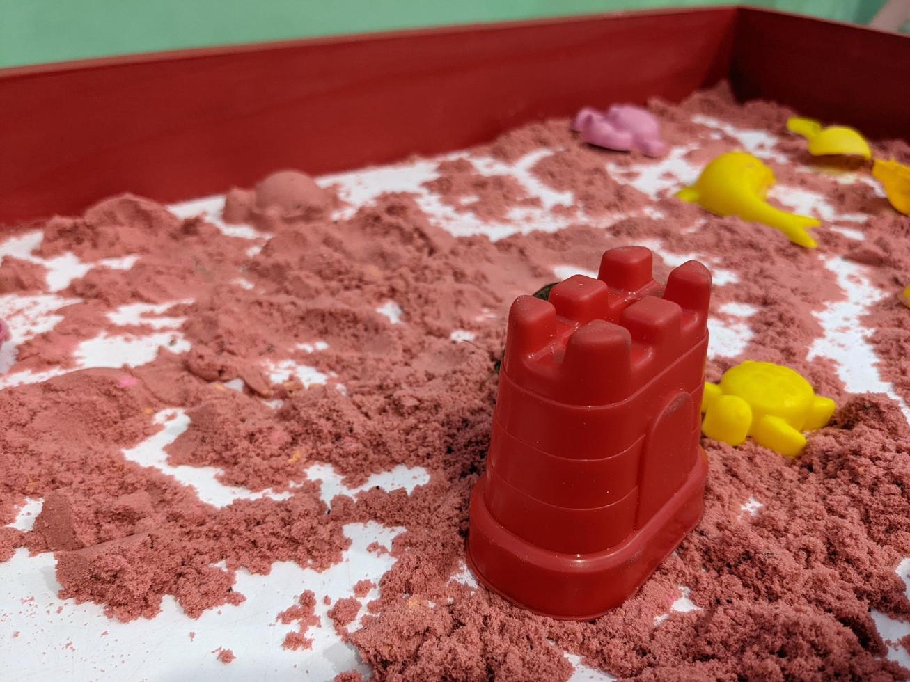 röd sand bygga för unge leksaker med gjutning. Foto är lämplig till använda sig av för leksaker bakgrund och unge utbildning innehåll media