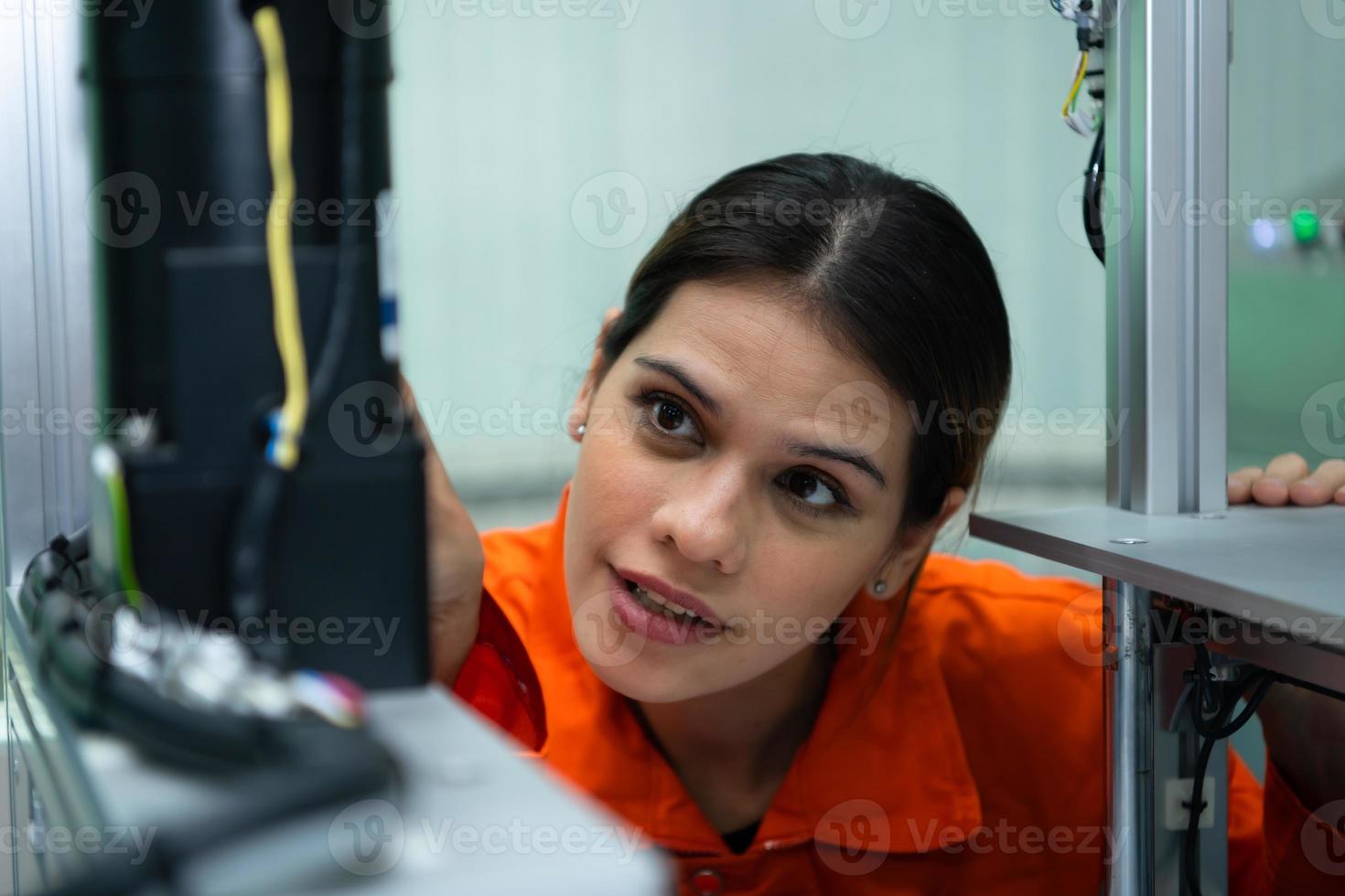 i ett elektronisk delar anläggningen, kvinna ingenjörer i de växt, inspekterande och testning robot händer Begagnade i de produktion av elektronisk komponenter. foto