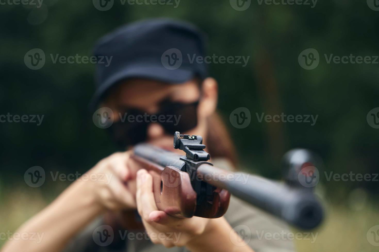 kvinna soldat munkorg vapen syn jakt mål grön löv foto