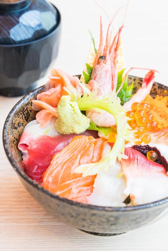japansk risskål med sashimi skaldjur på toppen foto