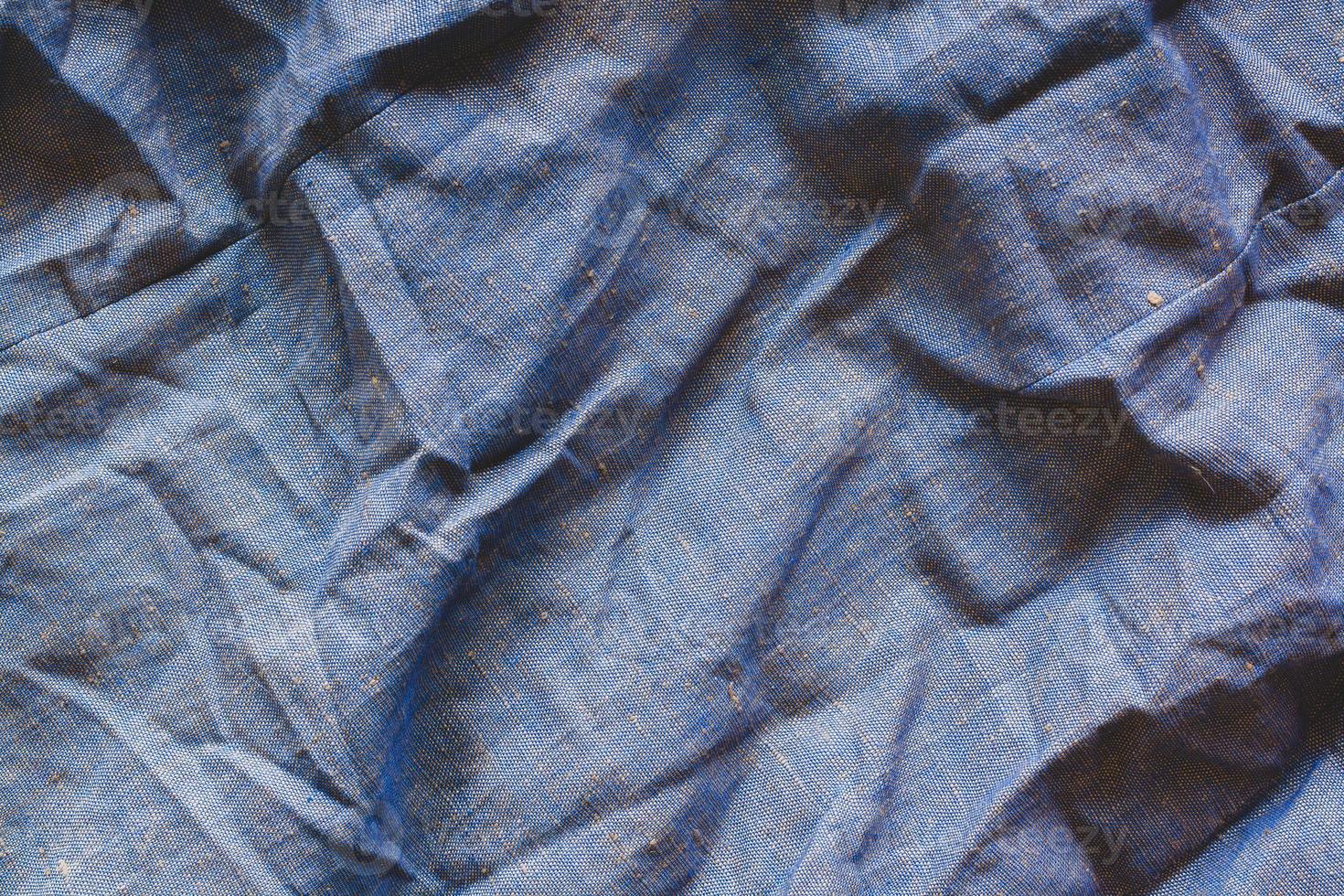de textur av de tyg. grov, tät tyg. mycket rynkig. blå och gul trådar. foto