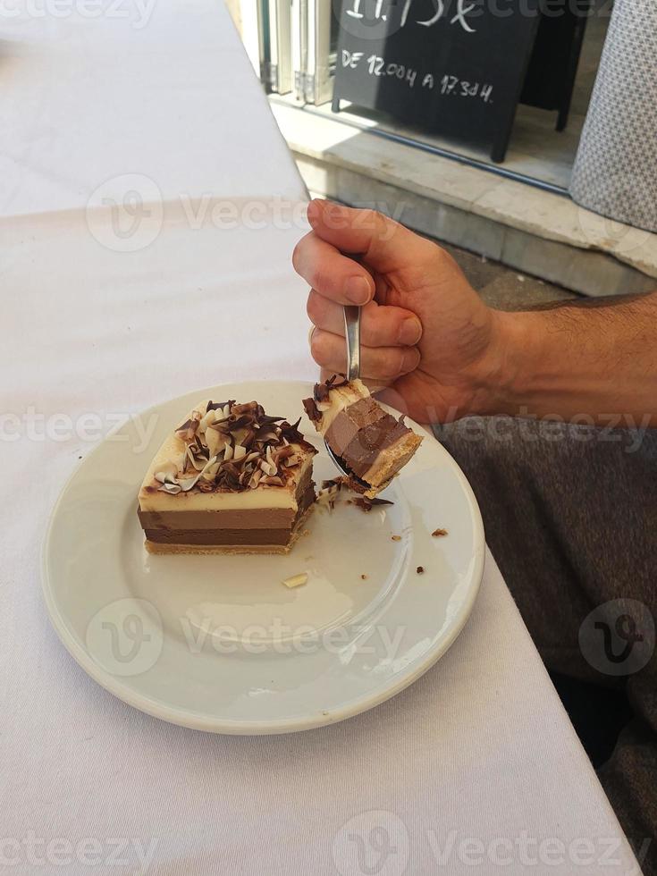 choklad efterrätt kaka uppäten med en sked i en Kafé bar i de färsk luft foto