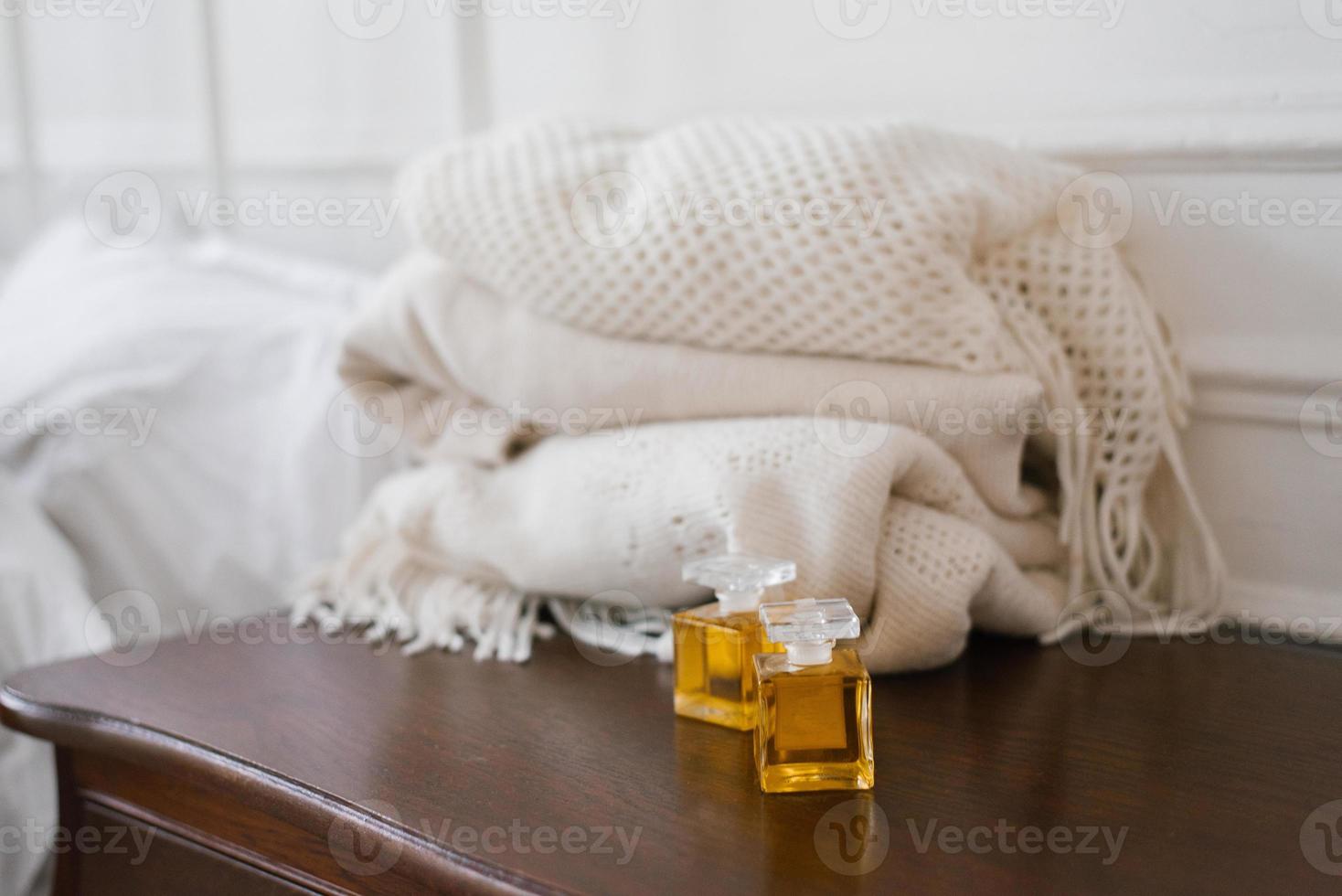 två glas flaskor med parfym eller parfym i årgång stil på de bedside tabell foto