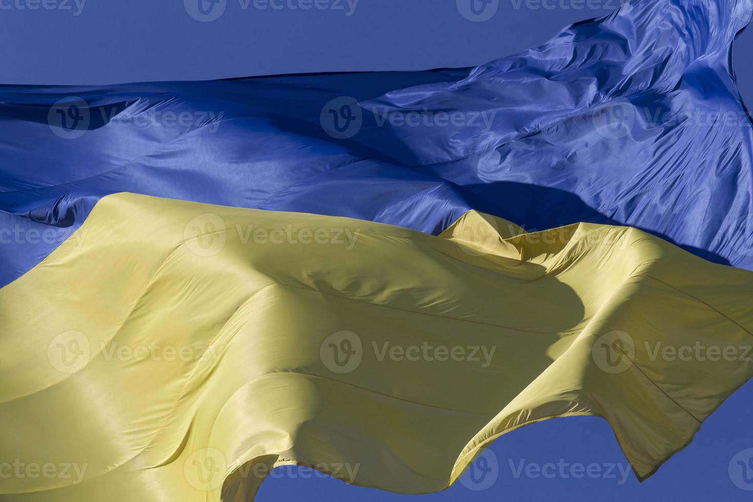vinkade ukrainska flagga mot blå himmel foto