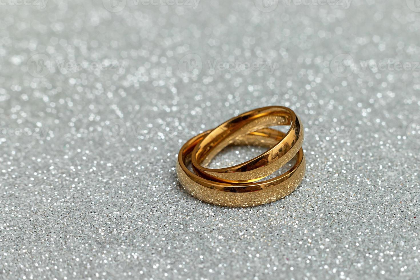 kommer du gifta sig mig. två gyllene bröllop ringar på silver- glitter bakgrund. engagemang äktenskap förslag bröllop begrepp. st. hjärtans dag vykort. baner på valentines dag. kopia Plats. foto