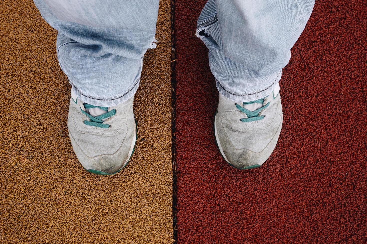 man med sneakers som går på gatan foto