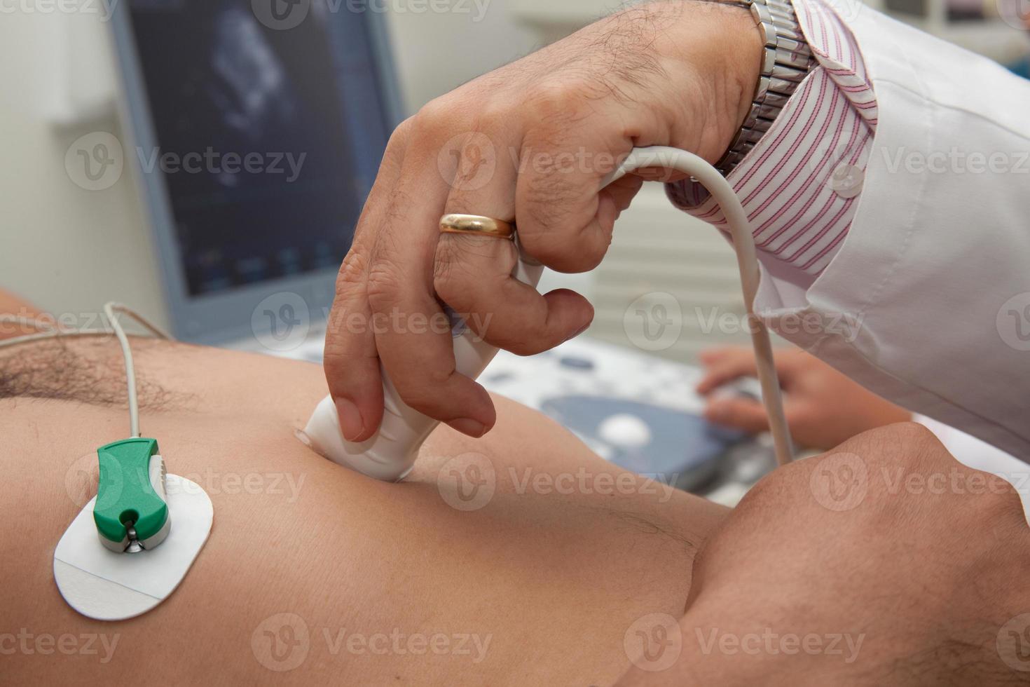 läkare utför ett ekokardiogram på manlig patient foto