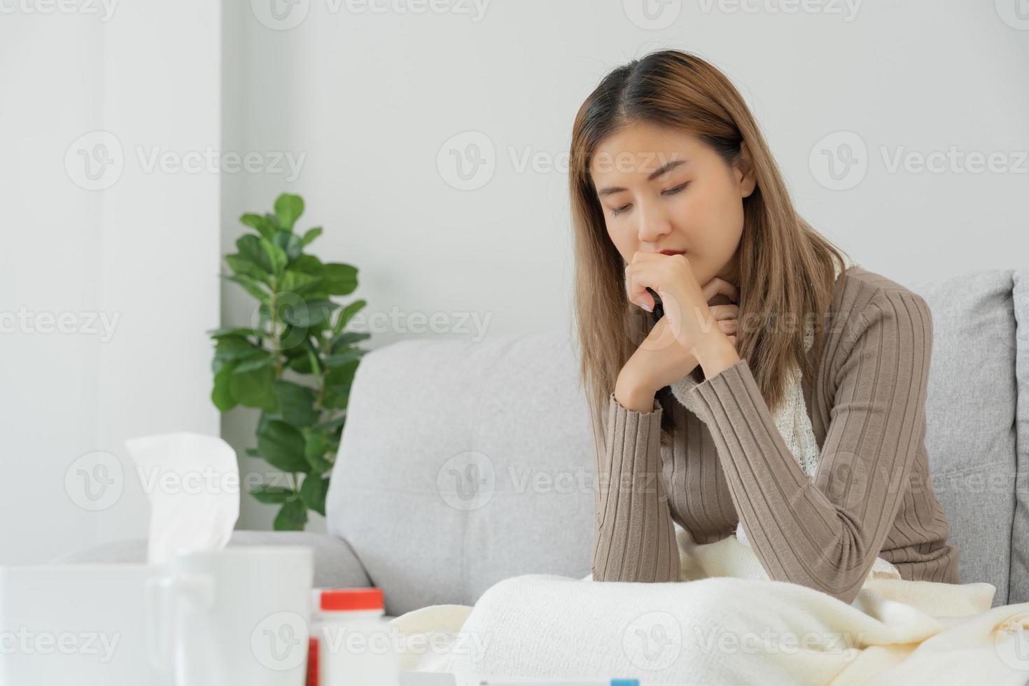sjuk kvinna med en huvudvärk Sammanträde under filt, kvinna nysning och rinnande näsa med säsong- influensa, allergisk, hög feber och influensa, vilar, virus, coronavirus, känna sjukdom, respiratorisk foto