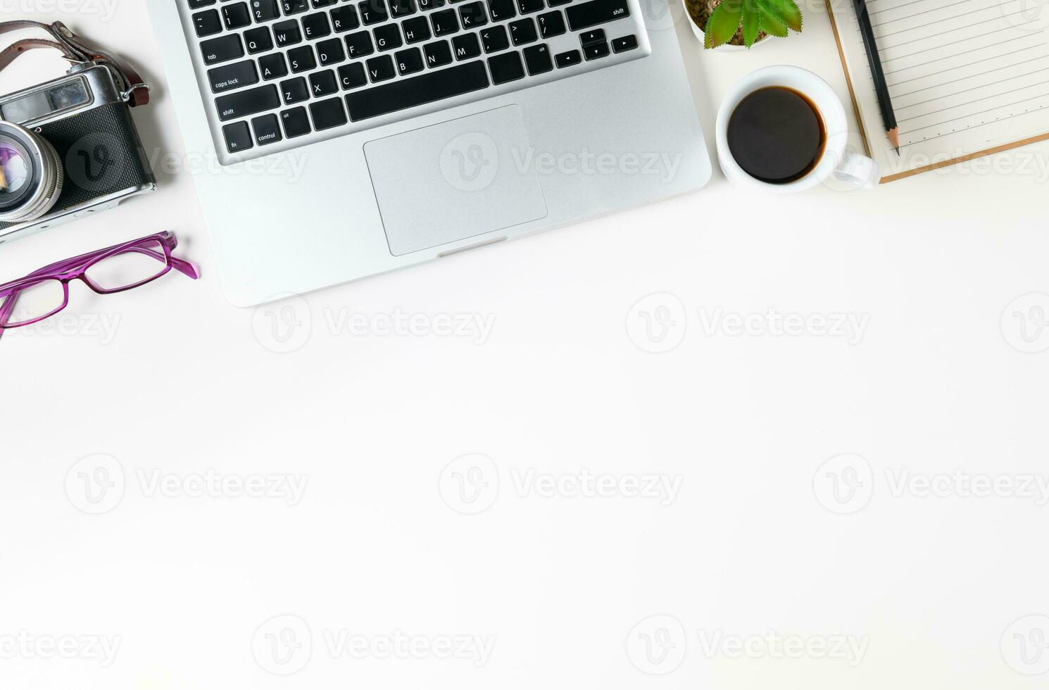 vit kontor skrivbord tabell med bärbar dator dator och årgång kamera foto