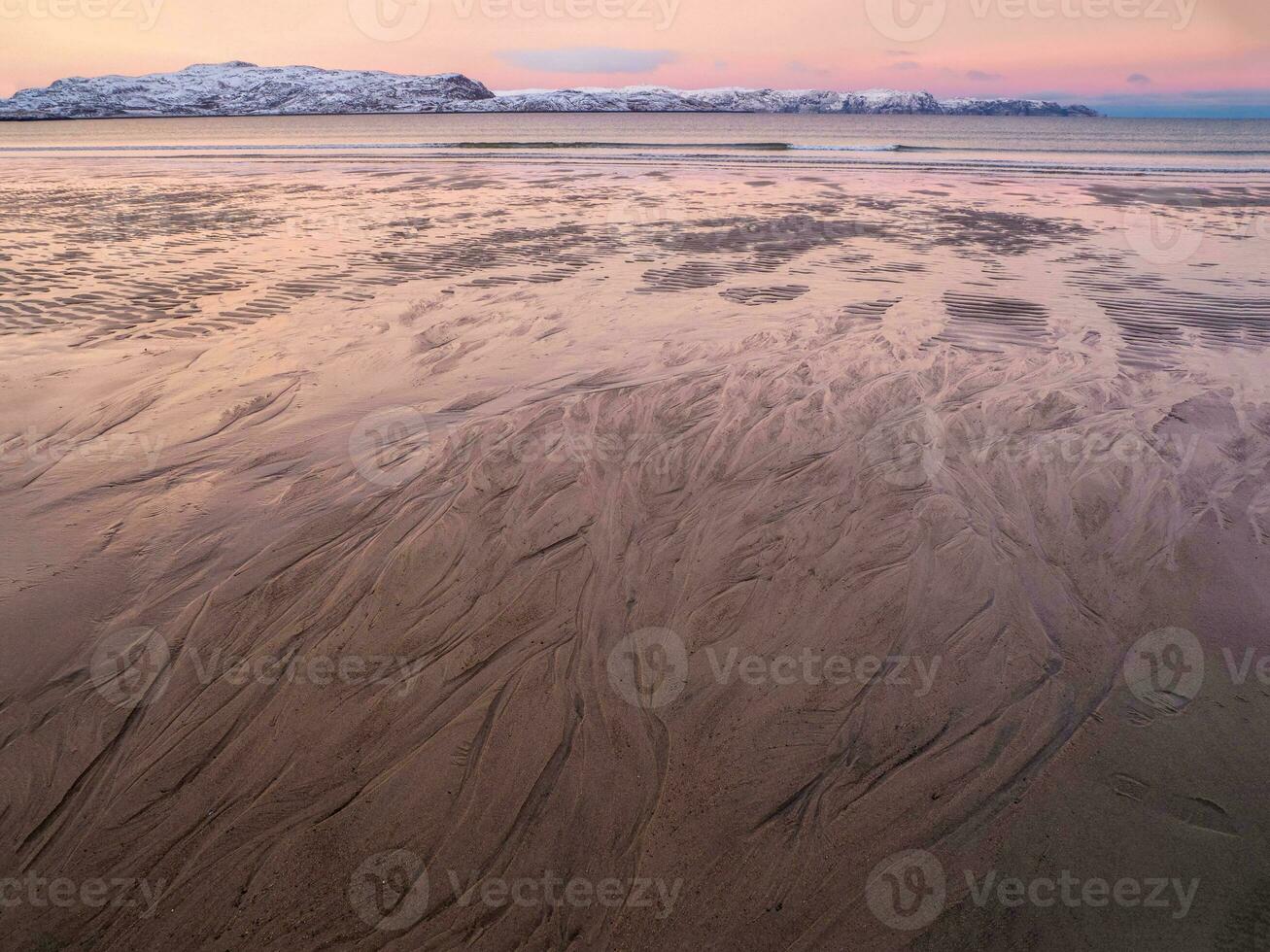 de textur av de sand på de hav strand på låg tidvatten på solnedgång. foto