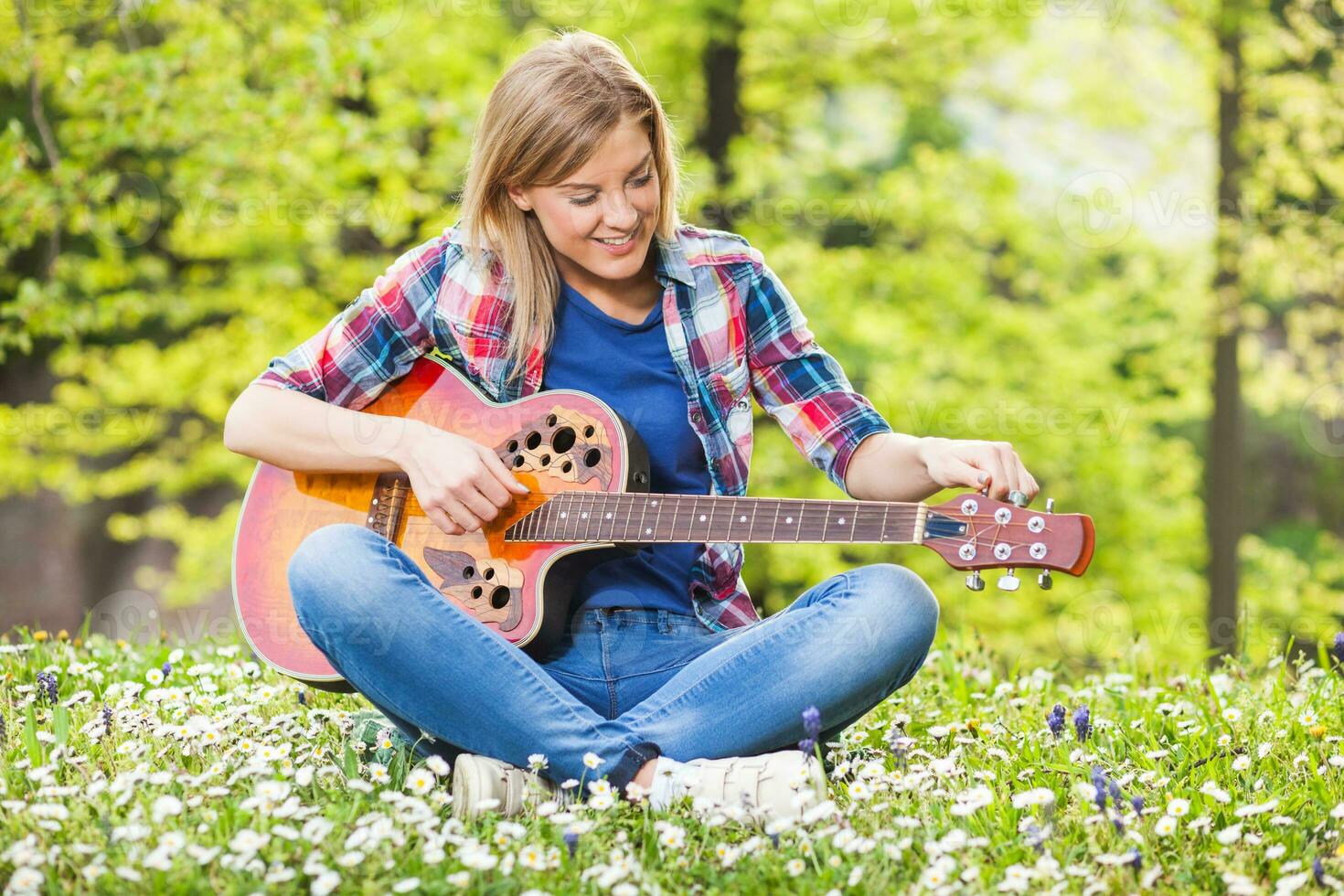 en kvinna spelar gitarr foto