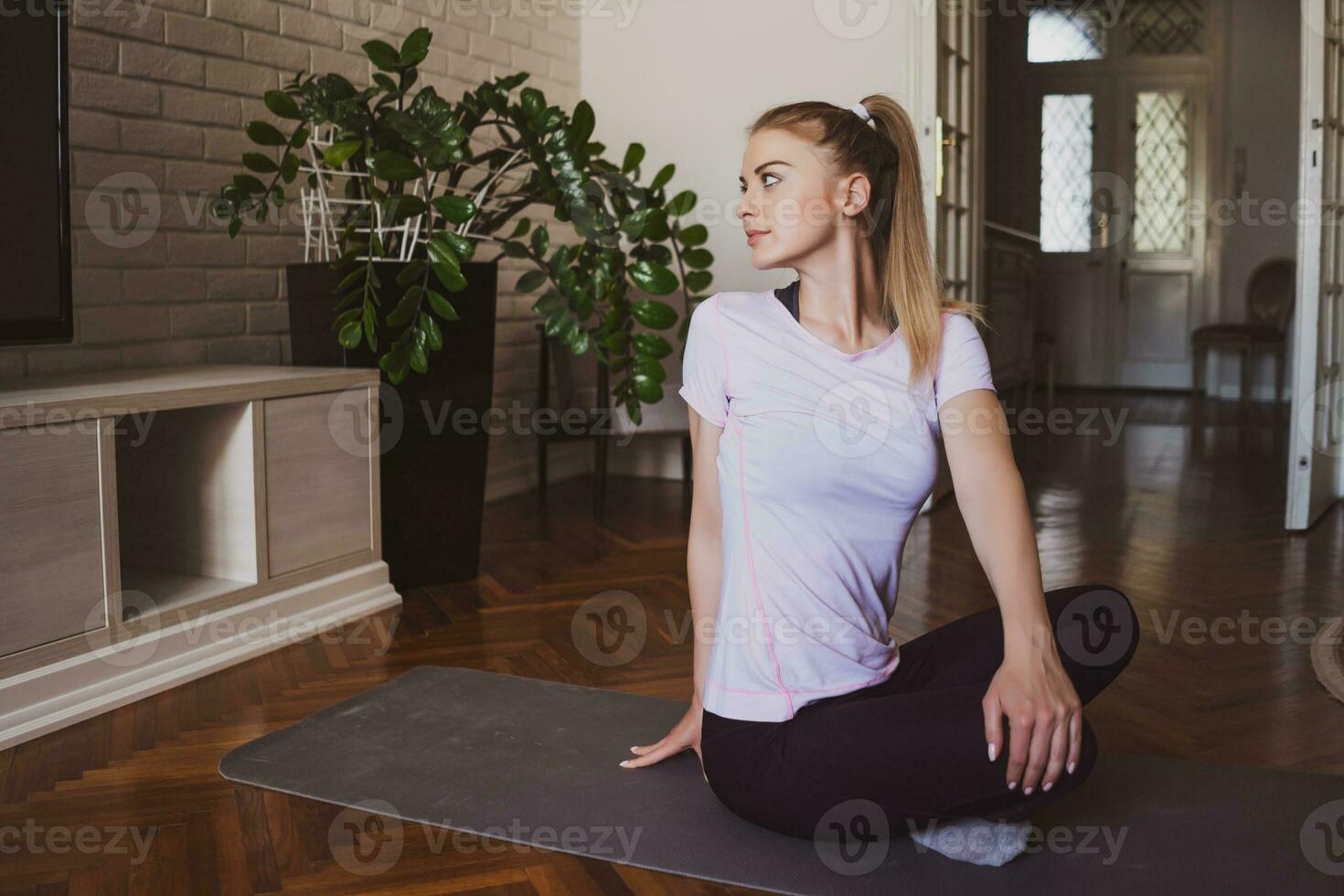 ung kvinna praktiserande pilates och yoga övningar på Hem foto