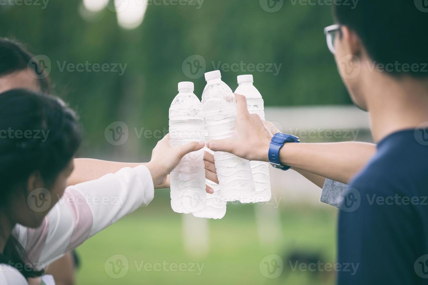 studenter som håller kallvattenflaskor på campus foto