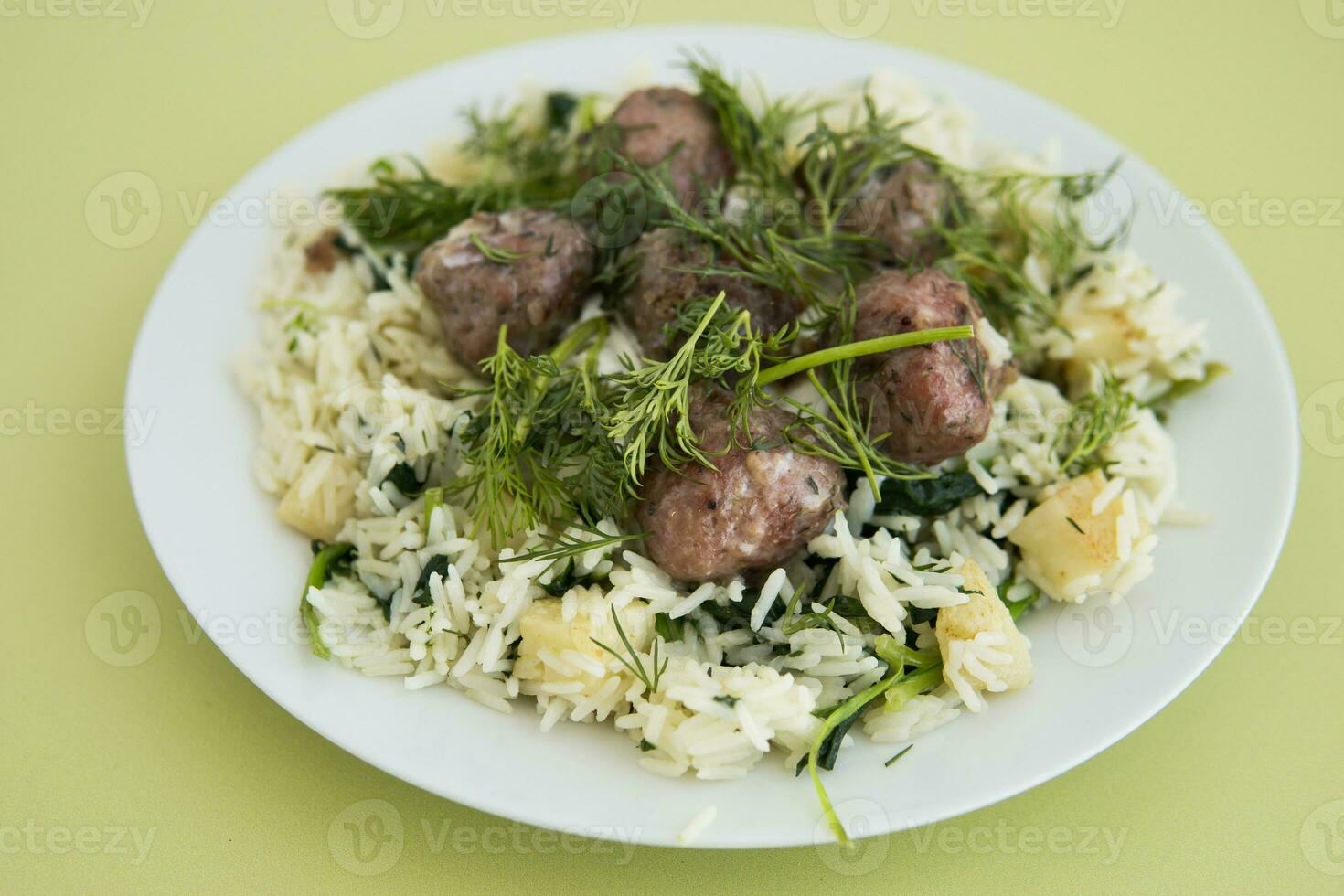 svenska köttbullar med dill, toppade med selleri och spenat ris. matlagning på Hem, hemlagad mat. foto