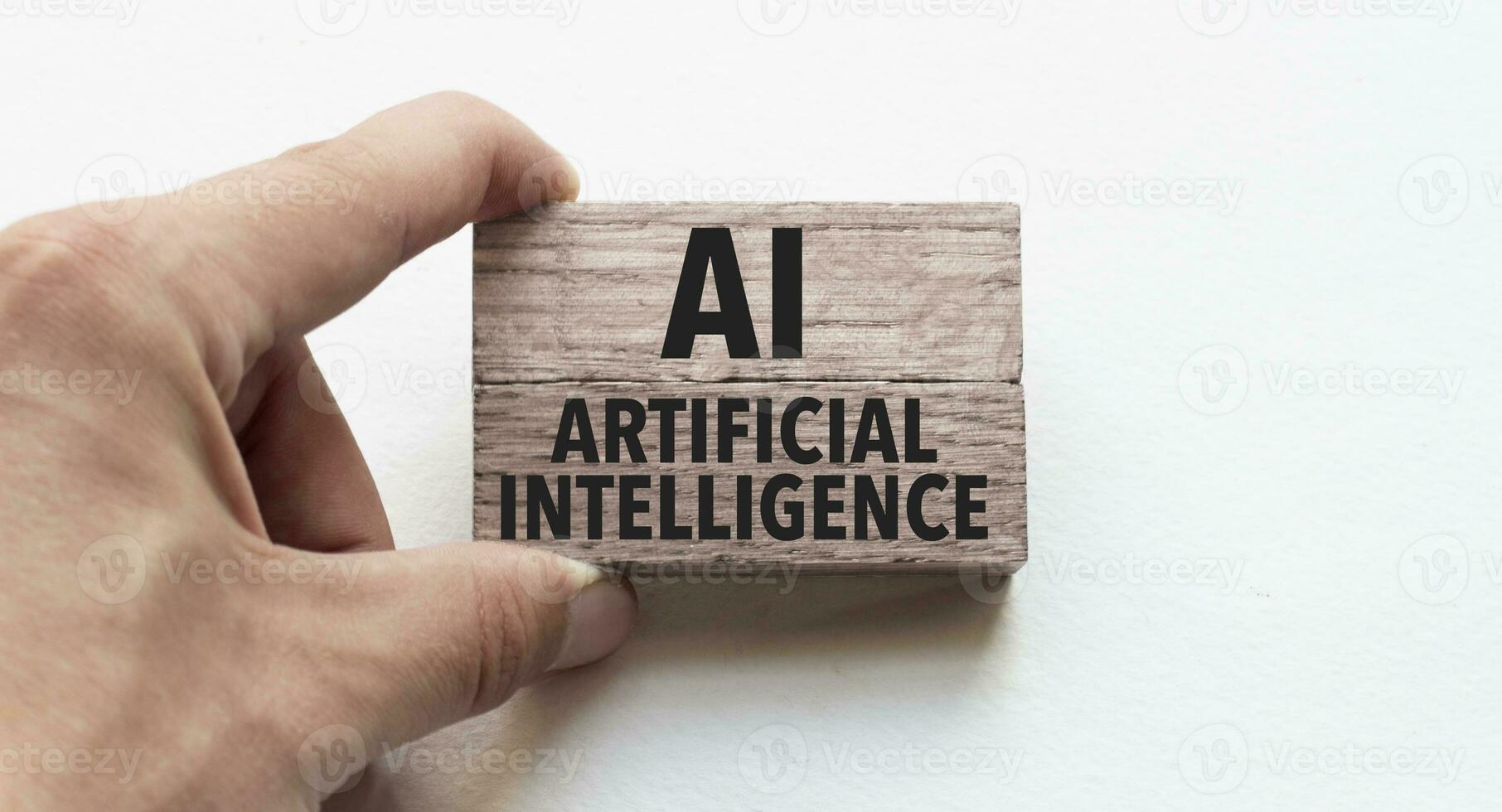 hand av en affärsman innehav trä- block. konceptuell bild. text ai - artificiell intelligens begrepp företag lyckas. foto