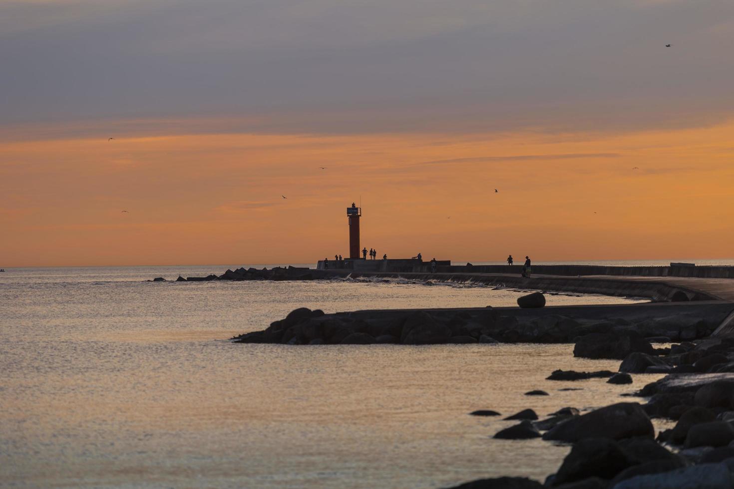 fyr vid ingången till hamnen i Riga på kvällen foto