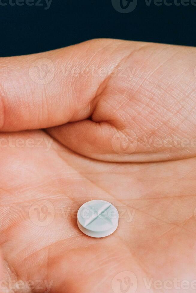 kvinna hand innehav en vit piller foto