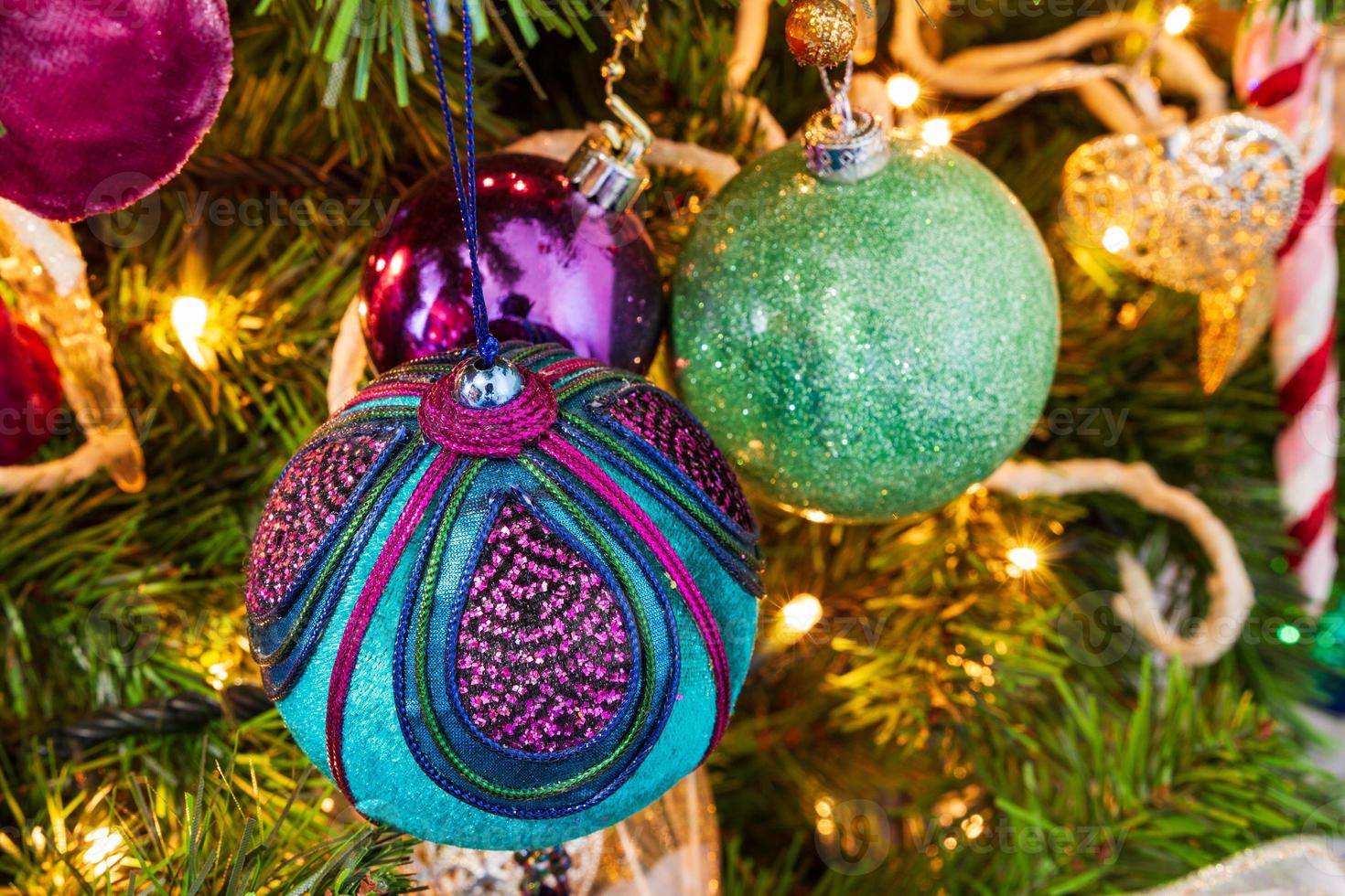 julgran med dekorativa bollar och ljusljus foto