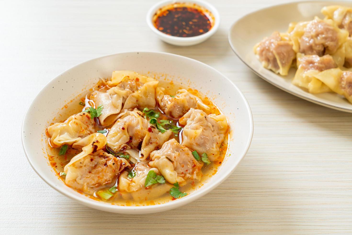 fläsk wonton soppa eller fläsk dumplings soppa med rostad chili - asiatisk matstil foto