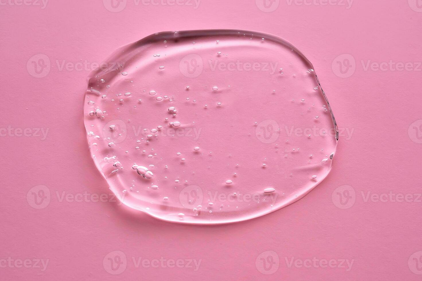 de textur av de kosmetisk gel på en rosa bakgrund. foto