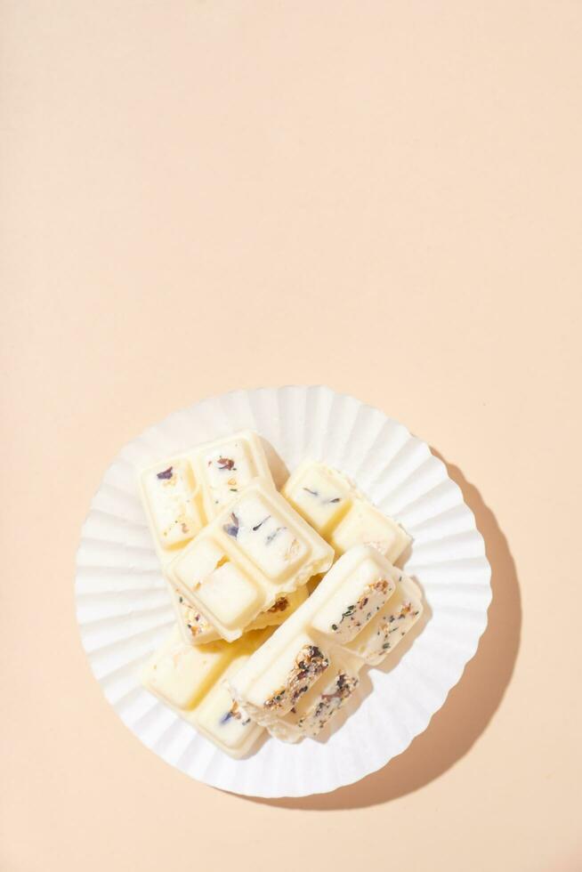 hantverk nötter vit choklad godis på beige bakgrund platt lägga, topp se foto