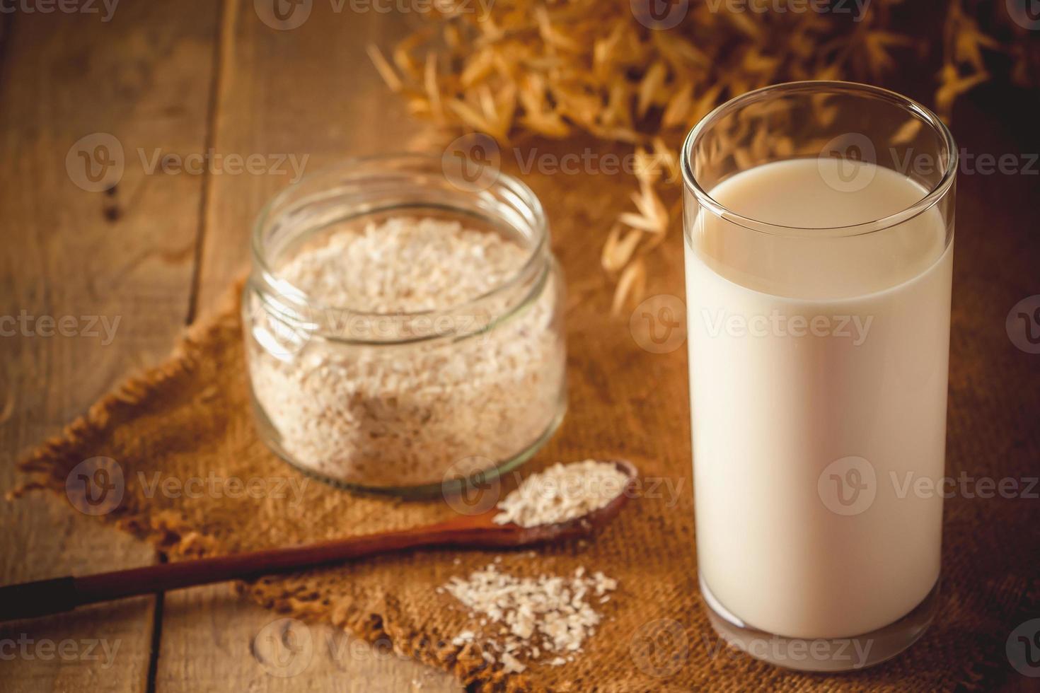 glas havre mjölk på en trä bakgrund foto