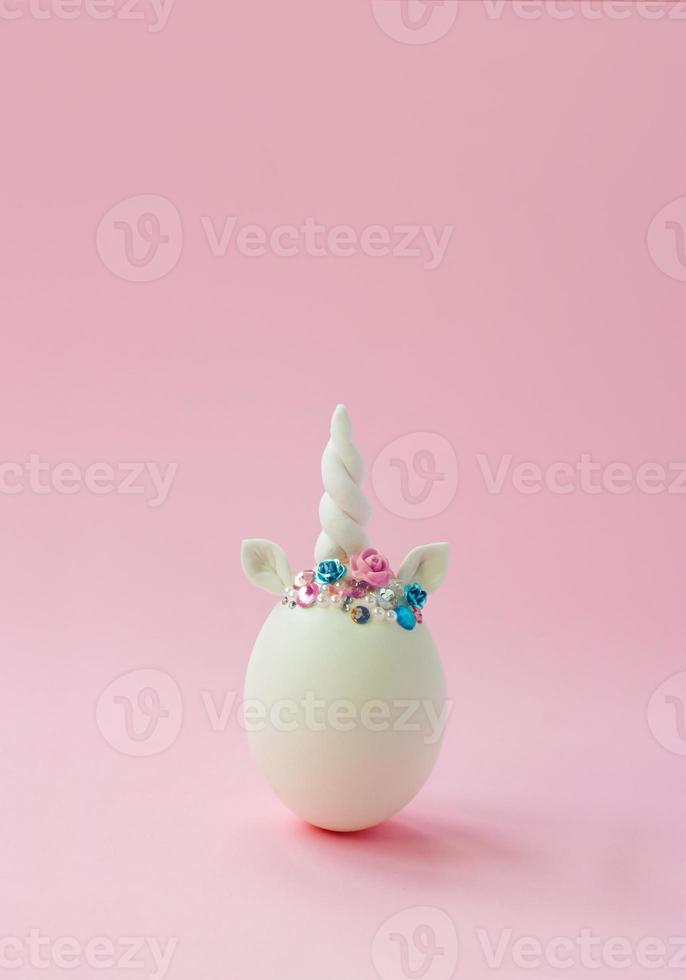 enda vitt ägg, med unicorn dekoration kreativ minimal påsk bakgrund med kopia utrymme foto