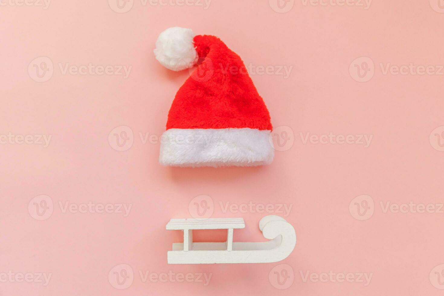 helt enkelt minimal sammansättning jul santa claus hatt kälke isolerat på rosa pastell färgrik trendig bakgrund foto