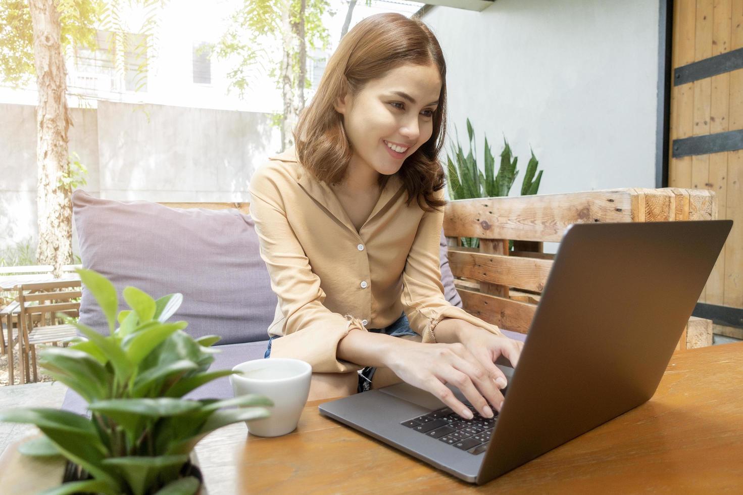 vacker affärskvinna arbetar med sin bärbara dator i kafé foto