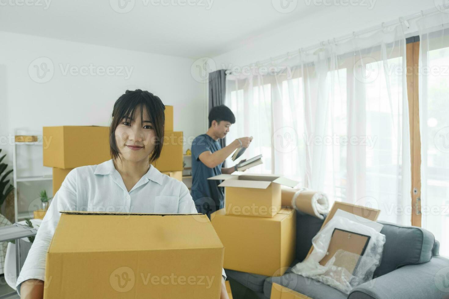 asiatisk ung Lycklig ny gift par rör på sig till deras ny hus eller verklig egendom. foto