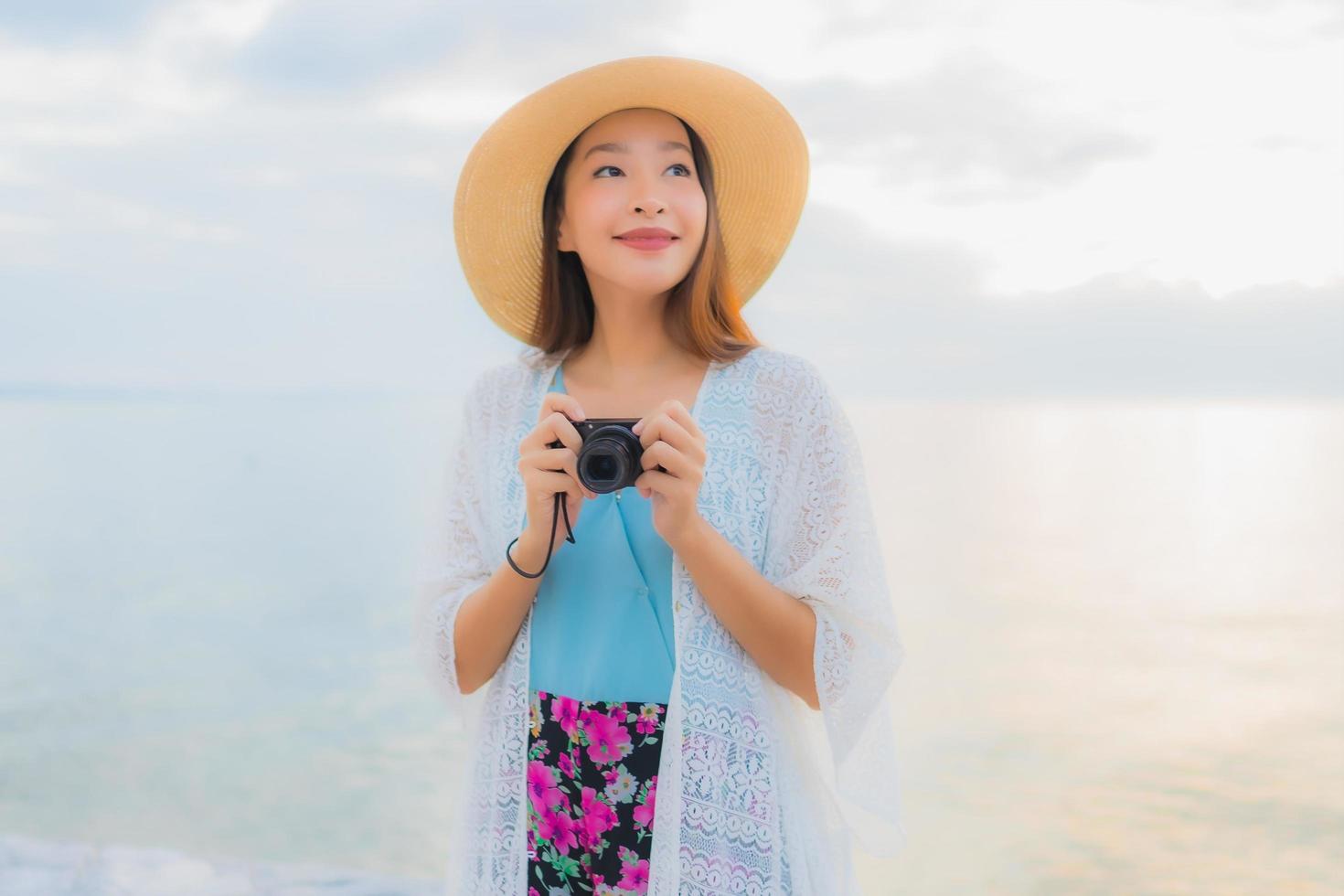 porträtt vackra unga asiatiska kvinnor lyckligt leende koppla av runt havet stranden havet foto