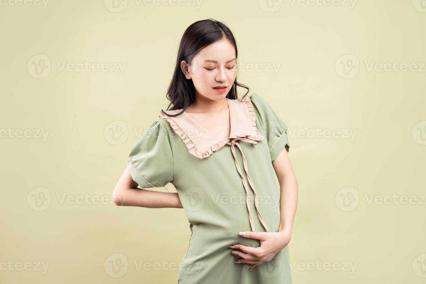 gravid asiatisk kvinna som känner sig trött under graviditeten foto