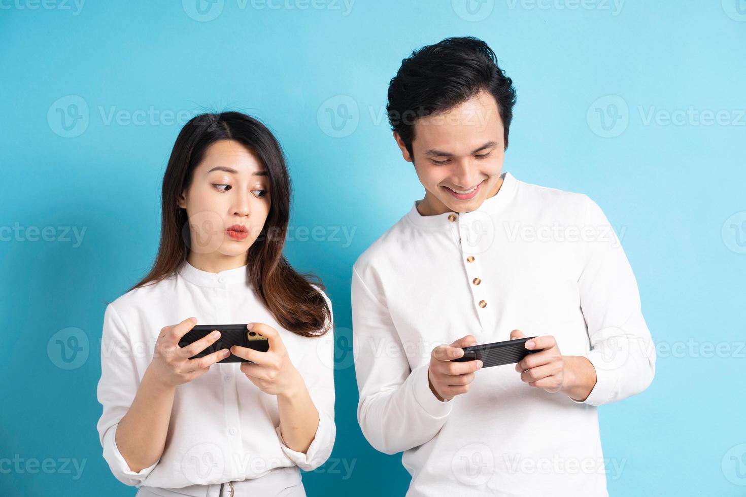 stående av ungt par som använder telefonen på bakgrund foto