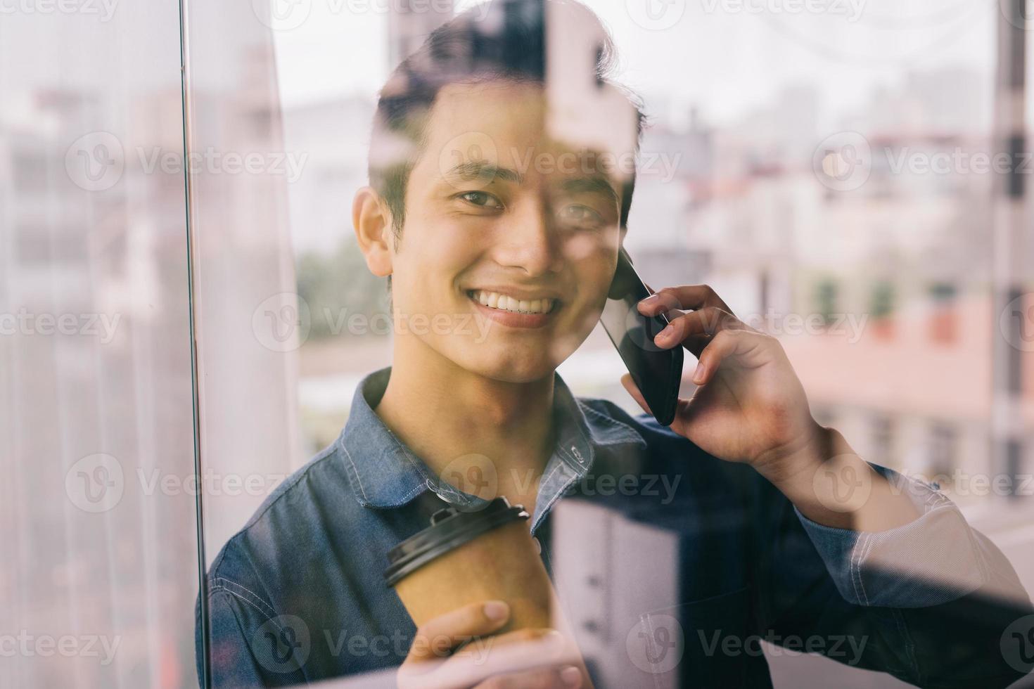 asiatisk man arbetar vid glasdörren foto